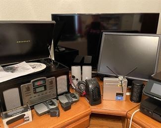 Crosley record player/radio, 40" Samsung flat screen TV, Dell flat screen monitor, linksys, radios