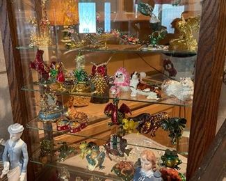 This showcase is on the front register table and contains, highly decorated trinket boxes, figurines