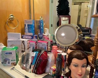 Lots of beauty aids, make up bags, brushes, magnifying mirror