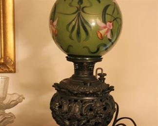 Antique oil lamp with glass globe shade