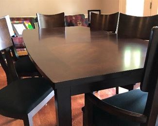 7 foot dining table, with one leaf in.  6 matching dining room chairs.