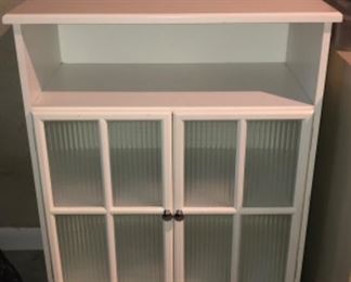 Laundry linen cabinet with ripple glass doors.
