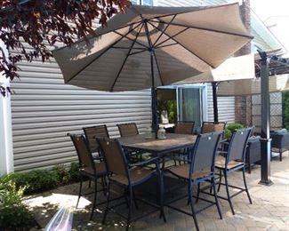 Sunbrella outdoor pub table with 8 chairs and oversized umbrella