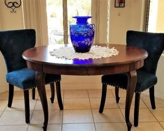 Vintage Victorian dining table with deep blue contemporary chairs.