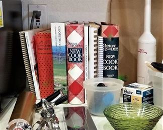 Cookbooks and utensils and lots of kitchen items 