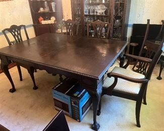 Antique dining table, 4 side chairs, 1 captains chair and pads