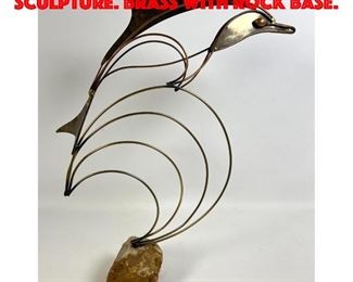 Lot 113 C JERE Dolphin Table Sculpture. Brass with rock base.