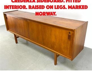 Lot 115 Norway Modern Teak Credenza Sideboard. Fitted interior. Raised on legs. Marked Norway.
