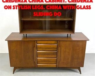 Lot 240 2 Part American Modern Credenza China Cabinet. Credenza on stylish legs. China with glass sliding do