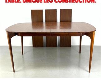 Lot 387 Italian style Walnut dining table. Unique leg construction.
