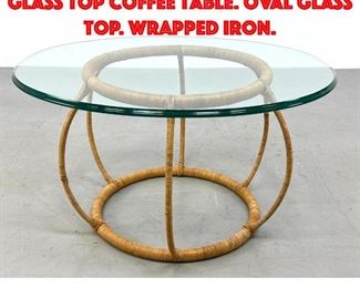 Lot 492 Rattan Bulbous Open Base Glass Top Coffee Table. Oval Glass Top. wrapped iron.