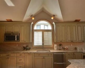 Beautiful kitchen cabinets by Mouser Custom Cabinetry. Cabinets are green in color.