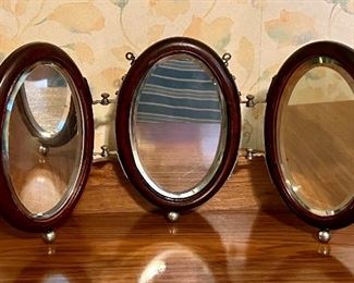 Late 1800s triptych traveling shaving mirror that both hangs or sits on balled feet and folds for storage