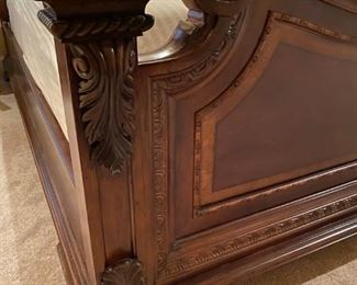 Beautiful Classic Queen Bed with Intricate Trim. It features four large posts with a layered base and swirled mahogany veneers