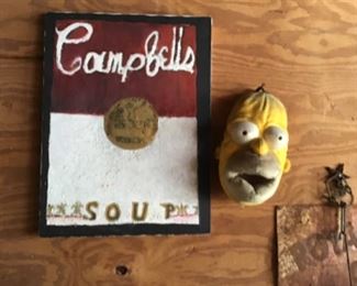 Bart Simpson, I see the corner of a sign.  May be Royal crown cola sign?  Not sure 