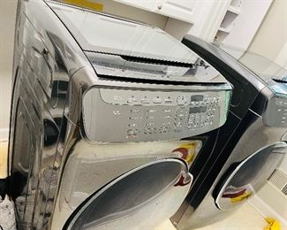 Samsung front loading washer and dryer with unique small washers and dryers on top of each one