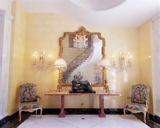 Hines' grand entry hall by famed architect Robert Stern. Note: the Kensington Palace chandelier and 4 sconces are hanging off site and can be seen by appointment. The Regence period armchairs are sold.