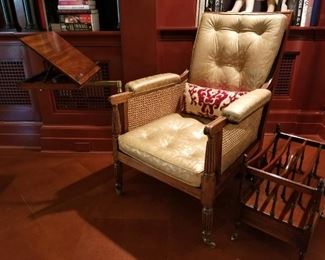 Generously scaled English Regency caned library arm/lounge chair w/original swing arm book slope upholstered in stenciled / gilded leather. Circa 1830.