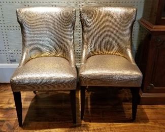 Two of four custom copper-gilt metallic woven dining chairs.
