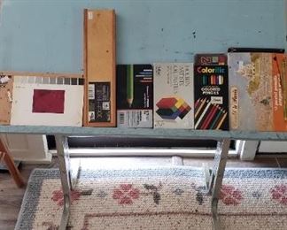 Drawing board, art supplies, floral rug