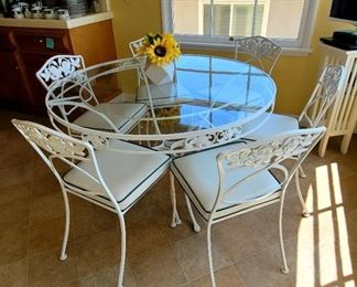 Wrought iron glass top table with 6 chairs