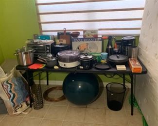 This table has a variety of great kitchen items from a roaster in the box to a dehydrator and some great new cast-iron pieces.
