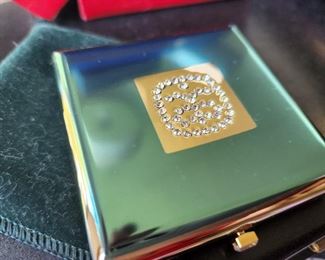 Vintage Powder Compact and no one has ever used the powder. In a protective jacket.