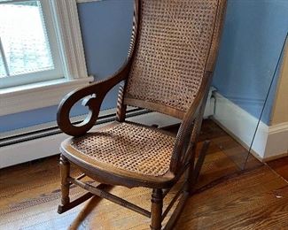 Low wicker bottom rocking armchair