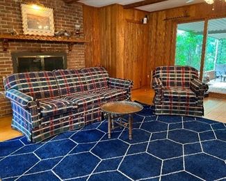 Matching blue green and red plaid upholstered Craftmaster 3 seat sofa & armchair atop a blue and white geometric patterned rug