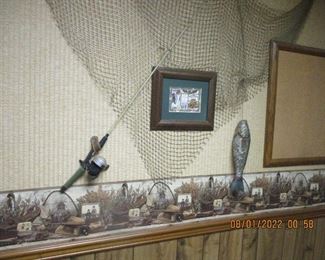 wall display with carved wood fish, old netting, etc