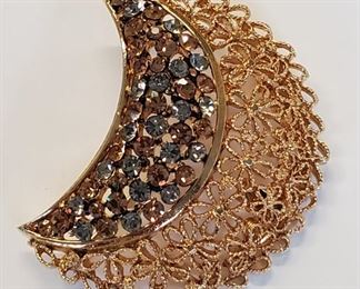 Vintage KARU ARKE Crescent Moon Rhinestone Brooch. Set with copper and silver colored rhinestones in goldtone filigree, this brooch was a collaboration between New York City designers Paul Kaufman and Jack Ruderman, who worked together from the 1950s to 1972. It is in like new condition and measures 2 1/8" long by 2" wide.