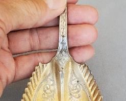 Serrated serving spoon made by Wilhelm Schulz and Emil Fischer (1868-1887), silversmiths to the gentry of San Francisco. Monogrammed ALN. Descended in the Nickerson family San Francisco. Weighs 74 grams.
