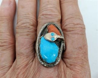 Turquoise, coral, and silver ring. Man's size 11. By well known Zuni artist Effie Calavaza. Efffie was born in 1928, and began working in 1956. She is now 94 years old. Her work incorporates the snake, as a symbol of rebirth and renewal.