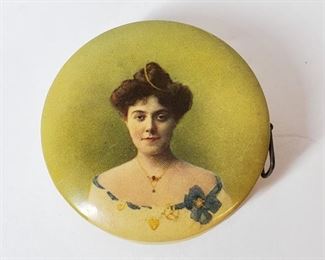 Celluloid tape measure with a beautiful woman on one side and advertising for the Fremont Stock Yard, Fremont NE on the other. In very good working condition.