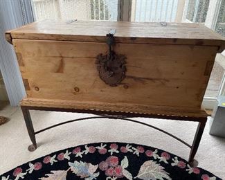 pine trunk on wrought iron stand