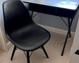 Simple Black Desk and Chair. Perfect for a smaller space with the desk measuring 32" x 20" x 29." The desk has been protected with a plastic cover, so it is in very good condition.  Desk by Forgiven and the is described as "poly and bark vortex modern chair with solid walnut legs" 