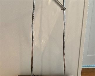 Pair of Modern Adjustable Table Lamps in a simple sleek design. Featuring a shiny chrome finish. Measuring about 30" high with adjustable features. 