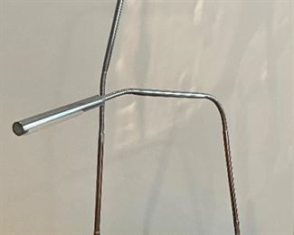 Pair of Modern Adjustable Table Lamps in a simple sleek design. Featuring a shiny chrome finish. Measuring about 30" high with adjustable features. 