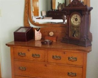 Vintage oak dress with swing beveled mirror.  Vintage Gingerbread clock on the dresser also for sale