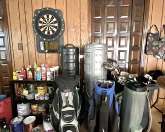 Golf accessories, travel bags, golf bags, dart board (a different one), spray paint and other paint accessories
