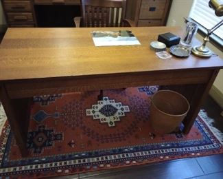 A very nice desk and hand woven rug