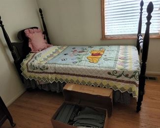 antique bed with Winnie the Pooh quilt
