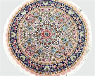 A 3.3' round Persian Tabriz rug.  Hand-woven multicolor floral design with central medallion on a Rose field.  Some edge damage with small tears.  ESTIMATE $100-200  NOTE: Includes Certificate of Authenticity from Mir's Oriental Rugs Inc., dated July 1997 in Ann Arbor, MI.  

