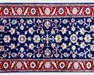 A 2.7' x 6' Indian Serapi runner.  Hand-woven multicolor floral design with Red border on a Navy Blue field.  Some wear to fringe, minor fading.  ESTIMATE $200-400   NOTE: Includes Certificate of Authenticity from Mir's Oriental Rugs Inc., dated July 1999 in Ann Arbor, MI.
