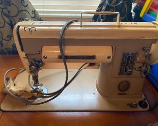 Singer sewing machine with wooden cabinet
