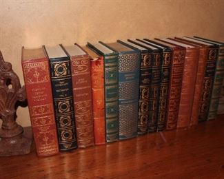 Iron scroll bookends surround the leatherbound novels