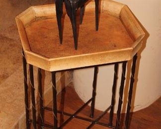 Octagonal etched leather tray table on a cast iron stand.