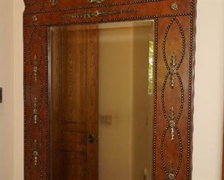 Ornately carved wood, iron & nail head wall mirror