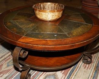 Stone topped coffee table with cast iron base