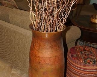 Tall hand made copper floor vase with dried sticks